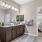 bathroom with a large mirror and toilet