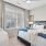 bedroom with nightstands on each side of the bed and a large window
