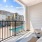 balcony with two chairs and a table overlooking a pool