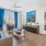 living room with a large window, coffee table, couch and chair