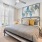 bedroom with nightstands on each side of the bed and a large window