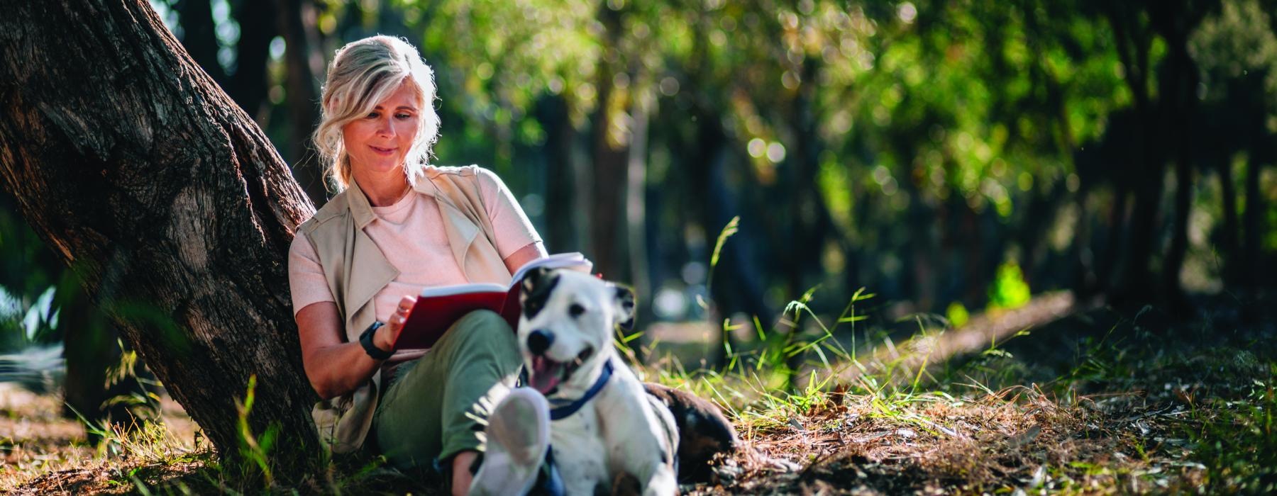 a person sitting next to a dog